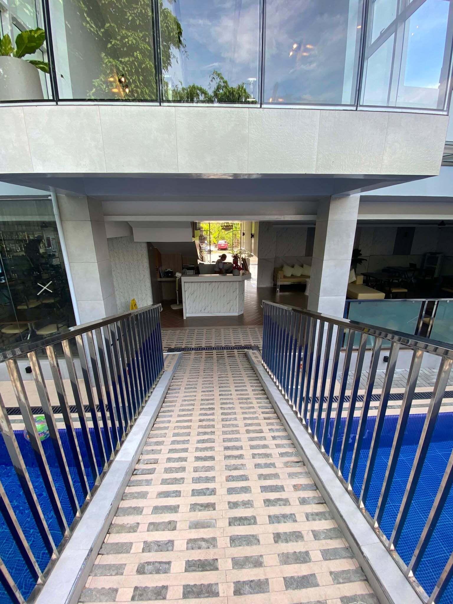 A modern building with a central courtyard, a pool, and a seating area.