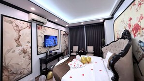 A hotel room with a bed, a television, a desk, and a chair. - Crown Luxury Hotel (Hanoi)