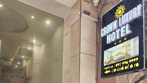 A hotel sign with a sun logo and stars, indicating a luxury hotel. - Crown Luxury Hotel (Hanoi)