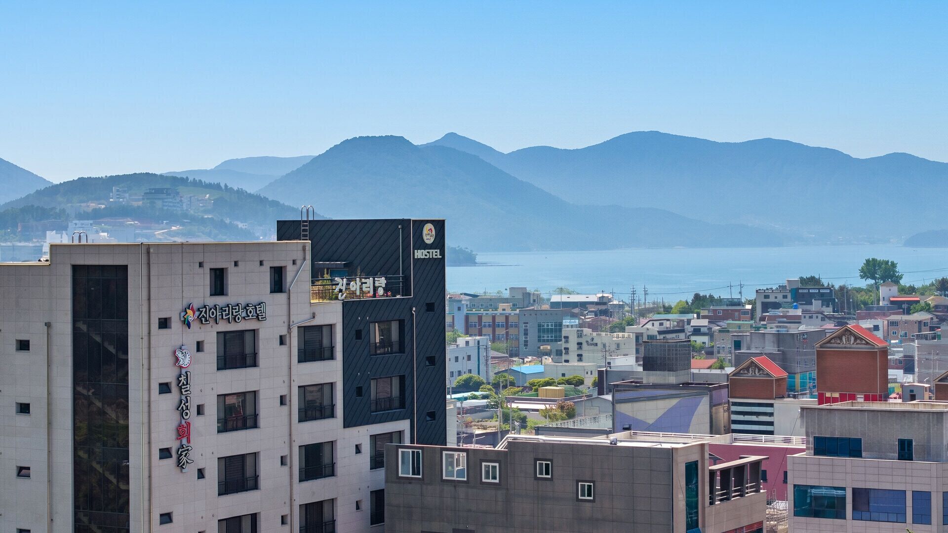A hostel with a view of mountains and a body of water.