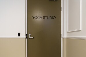 A door with the words 'YOGA STUDIO' on it, indicating a space designated for yoga activities. - Iconic Canberra Views with Pool and Gym (Canberra)