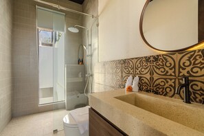 A bathroom with a shower, a sink, and a mirror. - Uluwatu 2 Bedrooms villa with Rooftop (Kec. Kuta Sel)