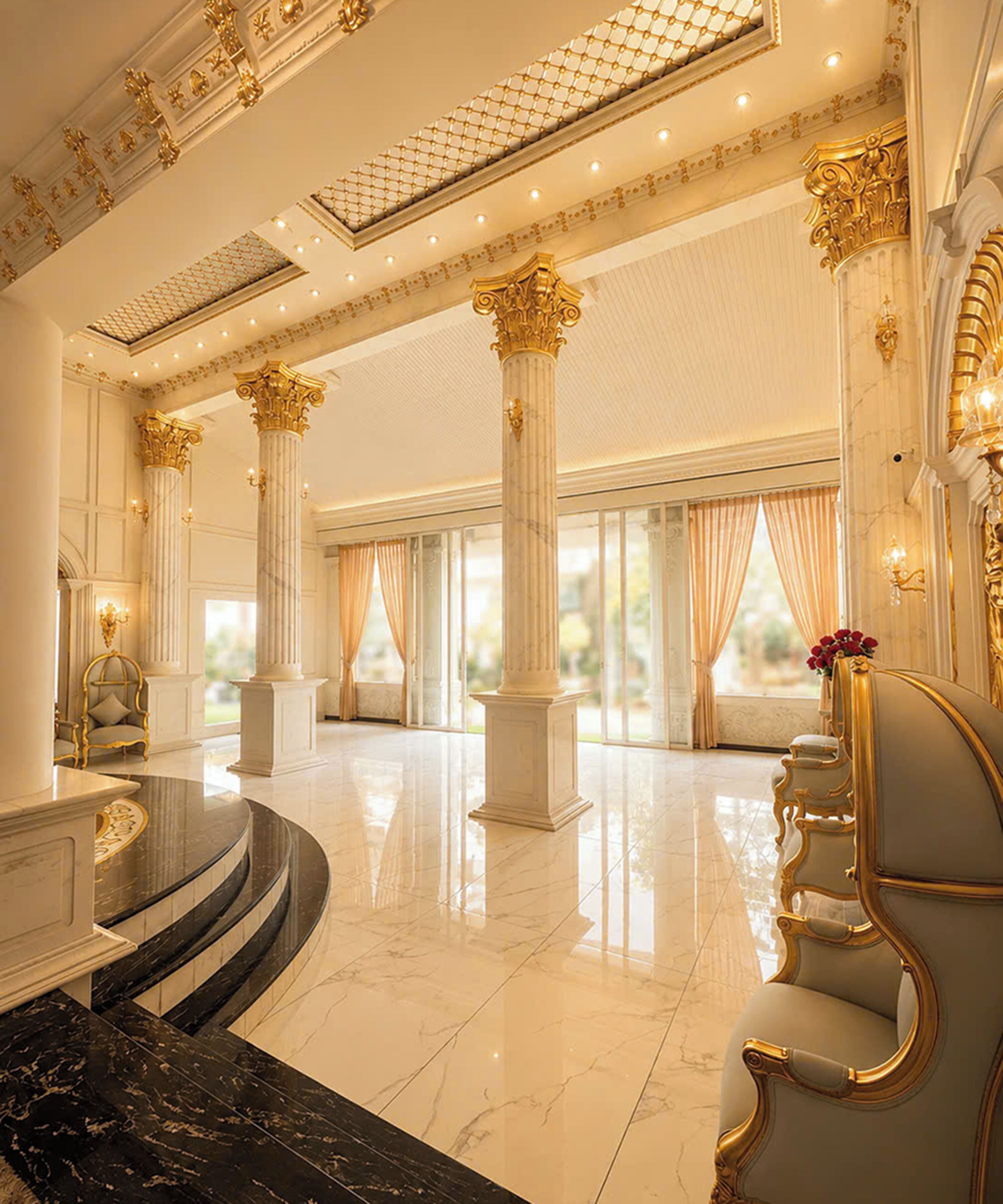 A grand lobby with marble floors, ornate columns, and a seating area with a curved bench.