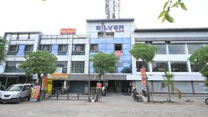 A building with a sign 'Silver ADE' and multiple signs for 'Hotel Vivan' and 'Hotel Grand.' - HOTEL VIVANTA (Ahmedabad)