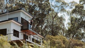 A modern two-story house with a balcony, surrounded by trees. - Panorama Escape, Port Sorell (Port Sorell)