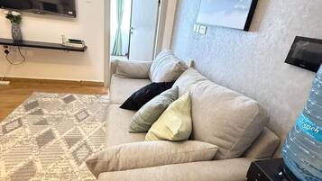 Classic Apartment, City View | Living area | 32-inch Smart TV with digital channels