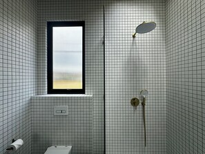 A bathroom with a window, a shower, and a toilet. - Seseh House by Alfred in Bali (Cemagi)