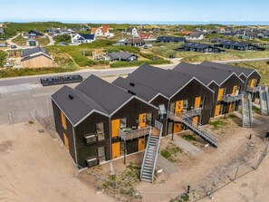 A modern building with multiple balconies and a staircase leading to an upper level. - "Ila" - 350m from the sea by Interhome (Ringkøbing)