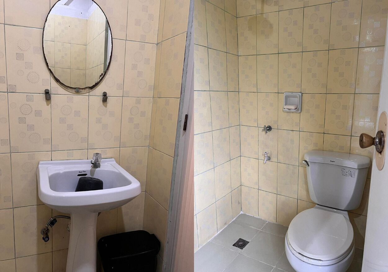 A bathroom with a sink, toilet, and mirror.