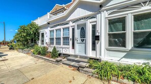 A two-story house with a front porch, a garage, and a driveway. - Spacious Newly Renovated Scenic Bay View Home Sleeps 1-8, Free Parking very safe (Ventnor City)