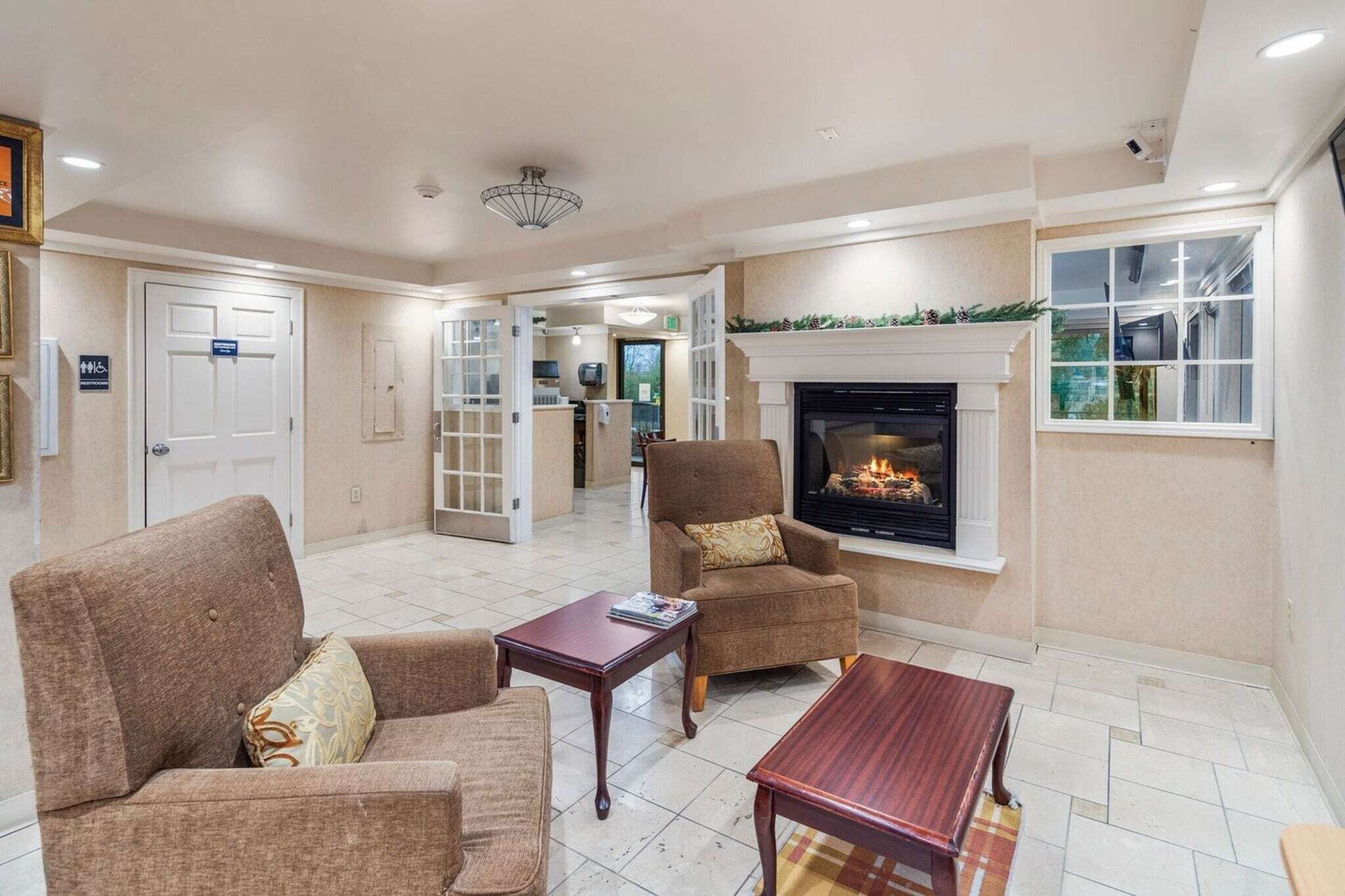 A living room with two sofas, a coffee table, and a fireplace.