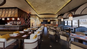 A restaurant with a bar area, multiple seating options including booths and tables, and a patterned ceiling. - Amiana Hotel Hanoi (Hanoi)