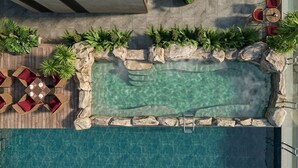 A rooftop pool with a wooden deck, lounge chairs, and potted plants. - Amiana Hotel Hanoi (Hanoi)