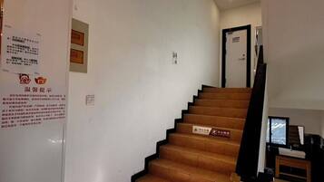 A staircase with wooden steps leading to a landing.