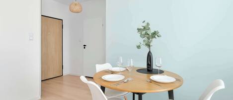 Comfortable dining area for two, ideal for enjoying breakfast, lunch, or a romantic dinner.