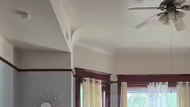 A living room with two sofas, a ceiling fan, and a window with curtains. - Spacious & Renovated 3BR/2BA Full Kitchen. Steps from McCormick Place & the Loop (Chicago)