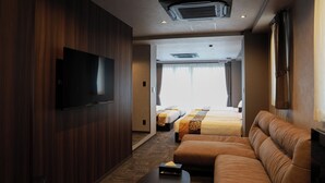 A hotel room with a TV, two beds, a sofa, and a flat-screen TV mounted on the wall. - OYADO LANTERN NAKASU KAWABATA (Fukuoka City)