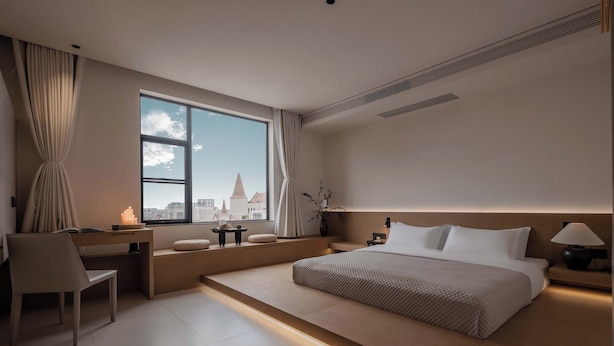 A modern hotel room with a large window, a desk, a bed, and a nightstand. - Silver Beach Puyue Designer Homestay (Beihai)