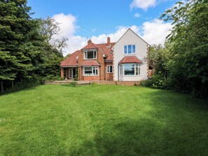 A two-story house with a red-tiled roof, a brick exterior, and a well-maintained lawn. - 331 Coniscliffe Road (Darlington)