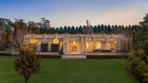 A two-story building with a symmetrical facade, multiple doors, and a well-maintained lawn. - Chateau Bowral (Bowral)