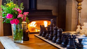A fireplace with a chessboard and pieces in front of it. - Chateau Bowral (Bowral)
