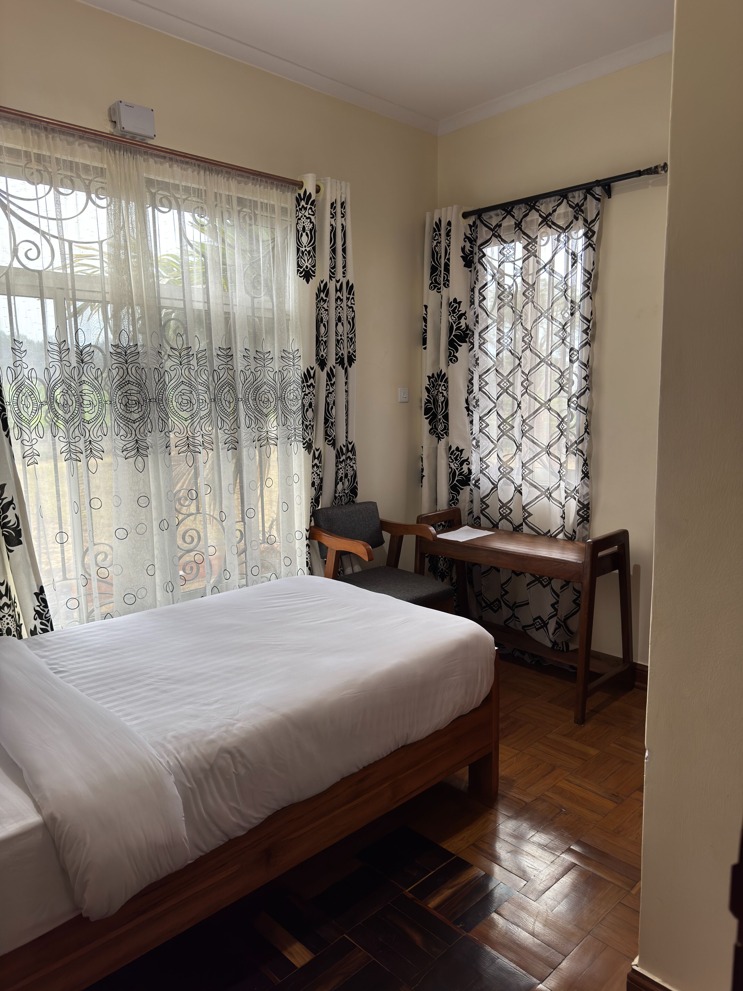 A room with a bed, a desk, and a chair.
