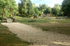 A playground with swings, slides, and climbing structures. - Guesthouse "Auf der Burg" OG (Andernach)