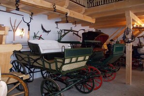 Ein Wagen mit roten Rädern und einem grünen Korpus, einer Holzzieldecke und einer Wandleuchte.