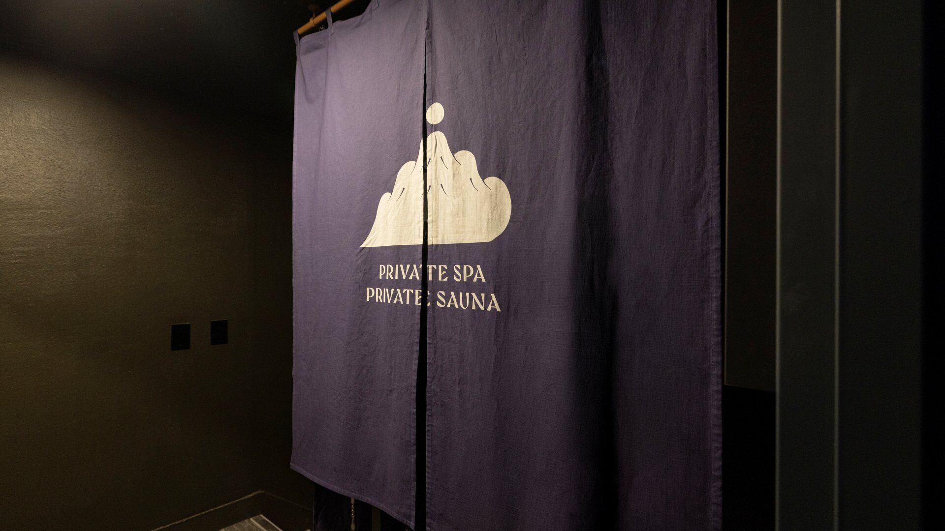 A private spa sign with a mountain and sun illustration, indicating a spa facility.