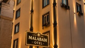 A multi-story hotel with a prominent sign reading 'MALABADI HOTEL.' - ÖZ MALABADİ OTEL (Mersin)