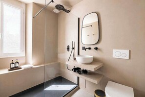 A modern bathroom with a glass shower enclosure, a white sink, a mirror, and a toilet. - Duplex Apartment with Pool a/c 2BR/4P - Cannes (Cannes)