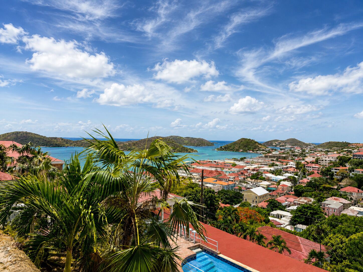 A coastal town with a view of the sea and hills.