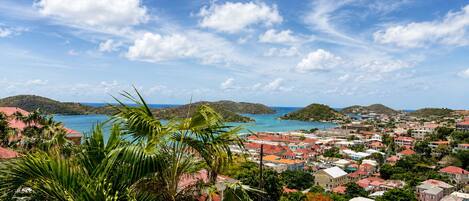 A coastal town with a view of the sea and hills.