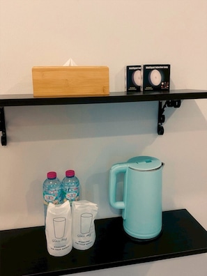 A shelf with a tissue box, two boxes of a product, and a teal mug. - Linlaada Property Kamala (Tambon Kamala)