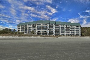 A multi-story hotel with a uniform exterior, located near a body of water. - Updated Luxury 3 BR Oceanfront Sea Cloisters New Kitchen & Baths Bike Rentals (Hilton Head Island)