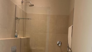 A small, modern bathroom with a shower, toilet, and sink. - 23 Grace (Cape Town)