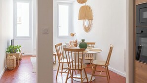 A dining area with a round table, chairs, and hanging pendant lights. - Beautiful, bright, and quiet one-bedroom apartment in the heart of the city, near the Old Port (La Ciotat)