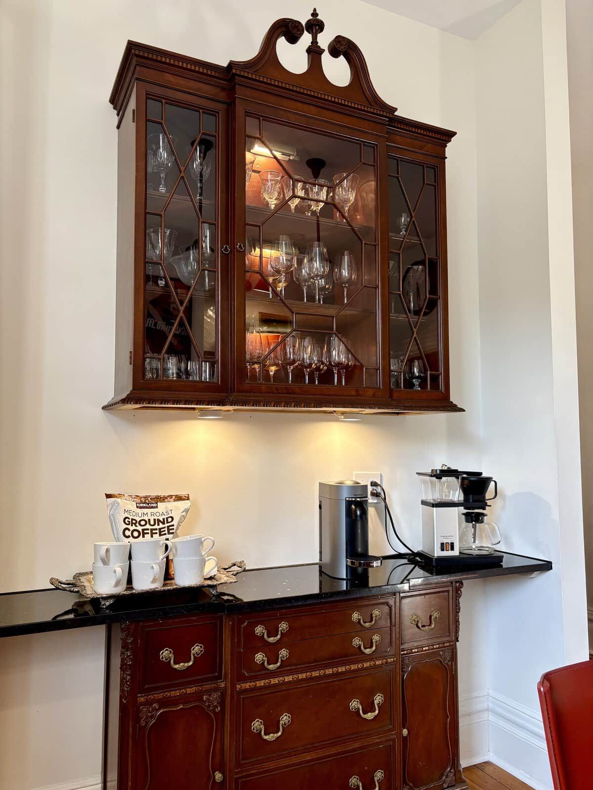 A china cabinet reborn as the coffee bar — Nespresso, drip, and the first stop every morning