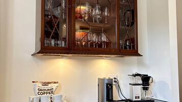 A china cabinet reborn as the coffee bar — Nespresso, drip, and the first stop every morning