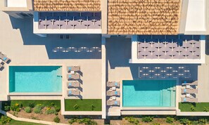An aerial view of a resort with two swimming pools, sun loungers, and a tiled roof. - Marea Villa Heated Pool (Dramia)