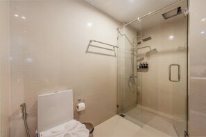A modern bathroom with a glass-enclosed shower, a toilet, and a towel rack. - Beachside 1BR•Walk to Rawai•Cozy-title rawai C201 (ตำบล ราไวย์)