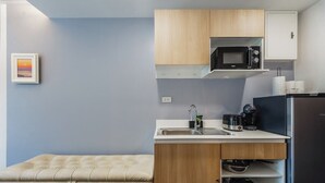 A compact kitchen with a microwave, coffee maker, and a refrigerator. - Beachside 1BR•Walk to Rawai•Cozy-title rawai C201 (ตำบล ราไวย์)