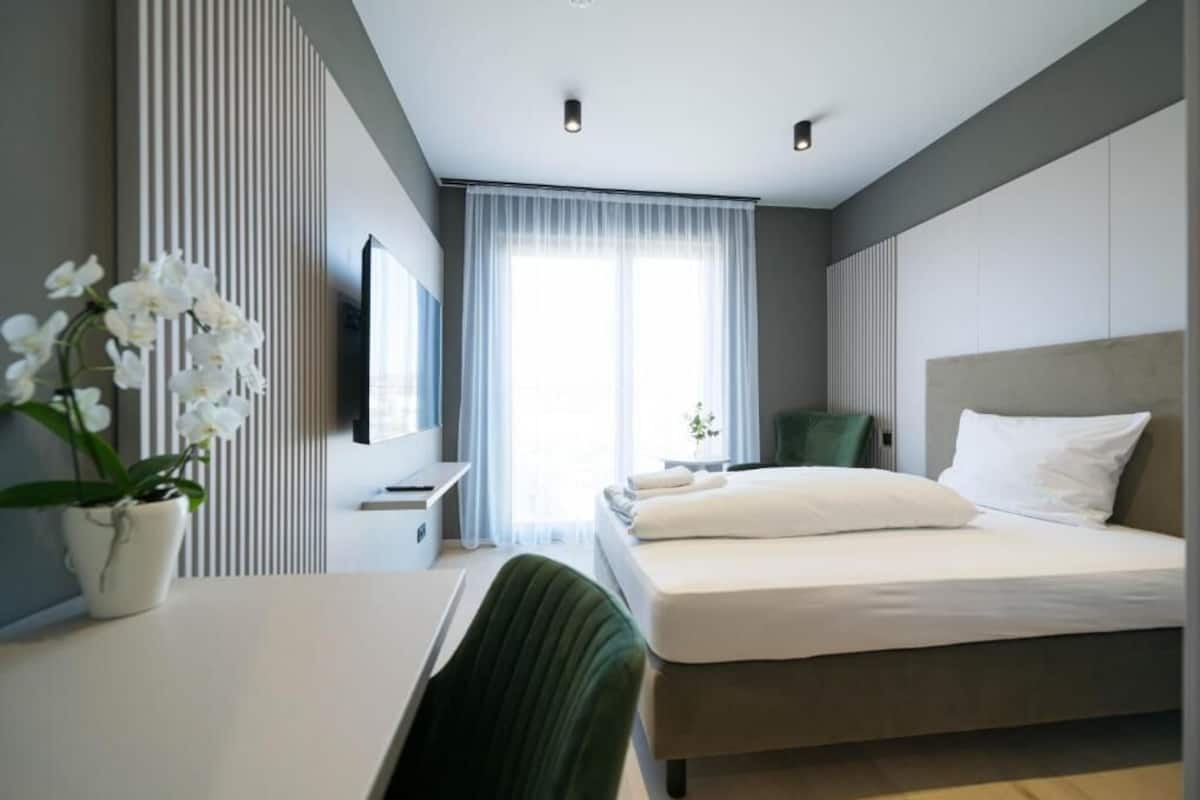 Standard Apartment, City View | Hypo-allergenic bedding available, laptop workspace, blackout drapes