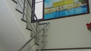 A staircase with metal railings leading to a landing. - Infinity Hotel by Kalra Hotels Amritsar (Amritsar)