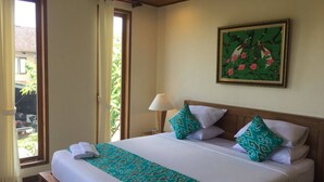 A hotel room with a bed, a painting, a window, and a door. - Room-a Quiet Room With Balcony in the he (Ubud)