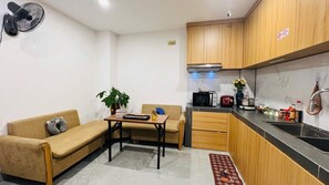Fridge, microwave, stovetop, cookware/dishes/utensils - My Home Hanoi Apartment & Rooftop (Ha Noi)