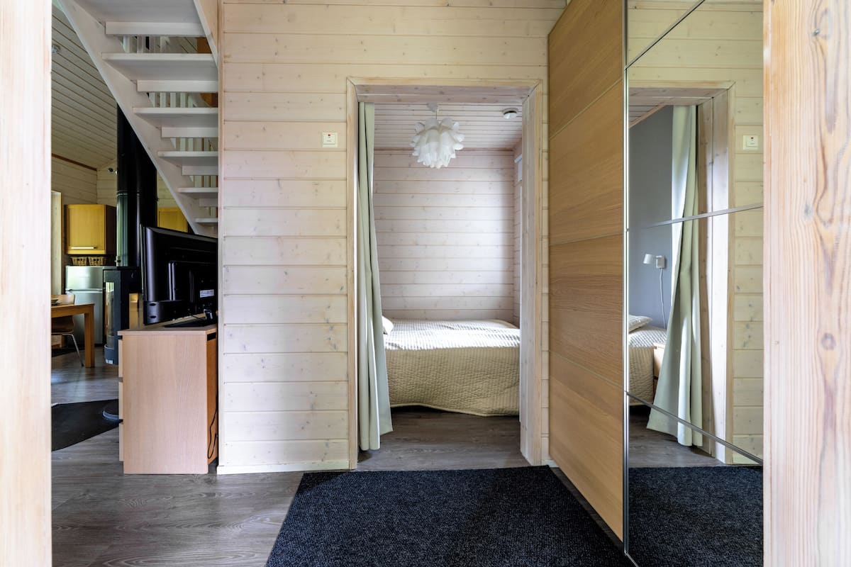 A room with a bed, a desk, and a mirror.
