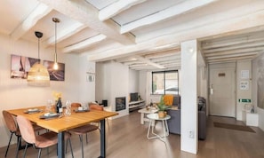 A modern interior with a dining area, a sofa, and a television. - Duinhalm - located in the heart of Nieuwpoort (Nieuwpoort)