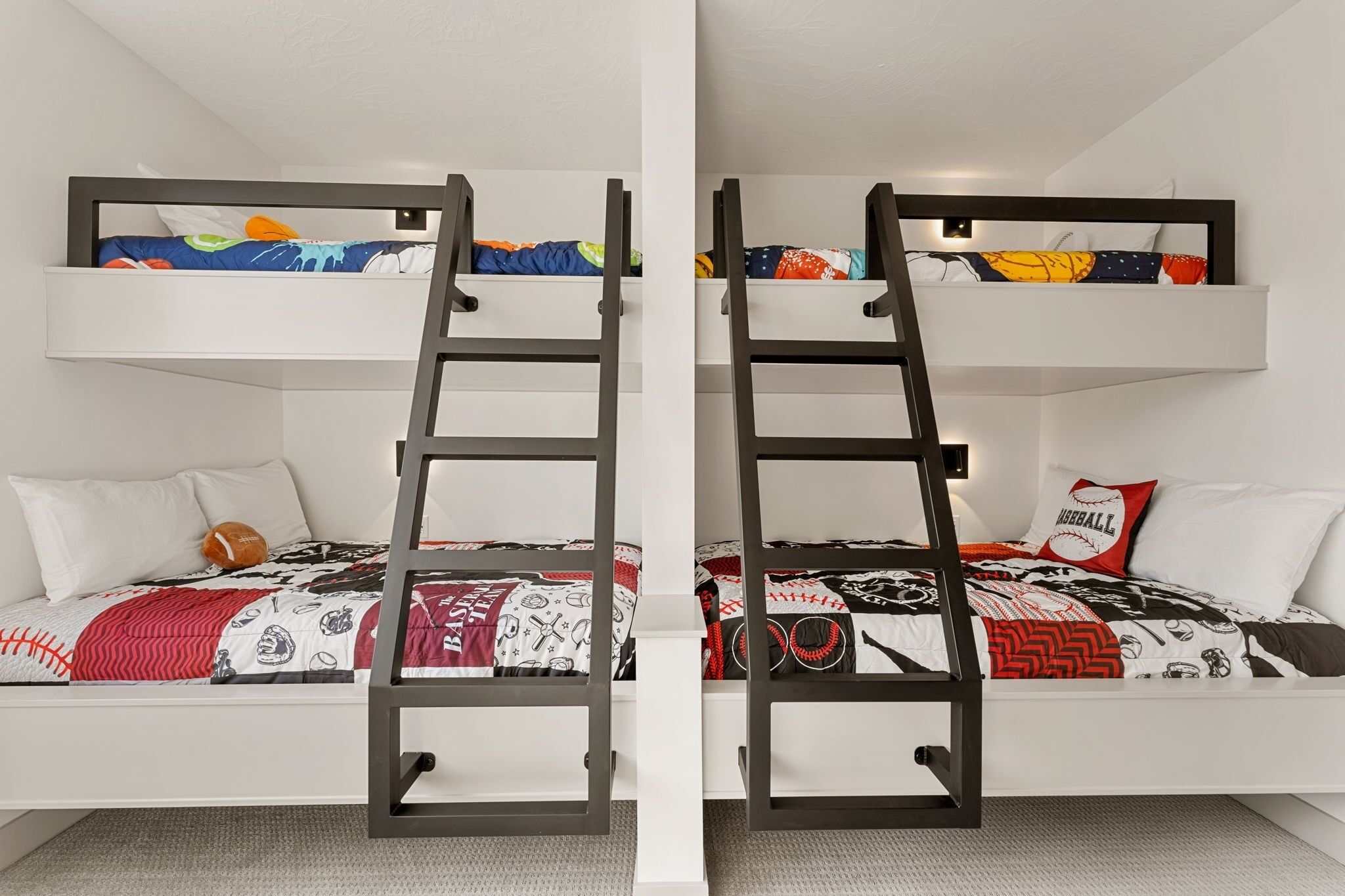 A bunk bed with a ladder, white walls, and a patterned bedspread.