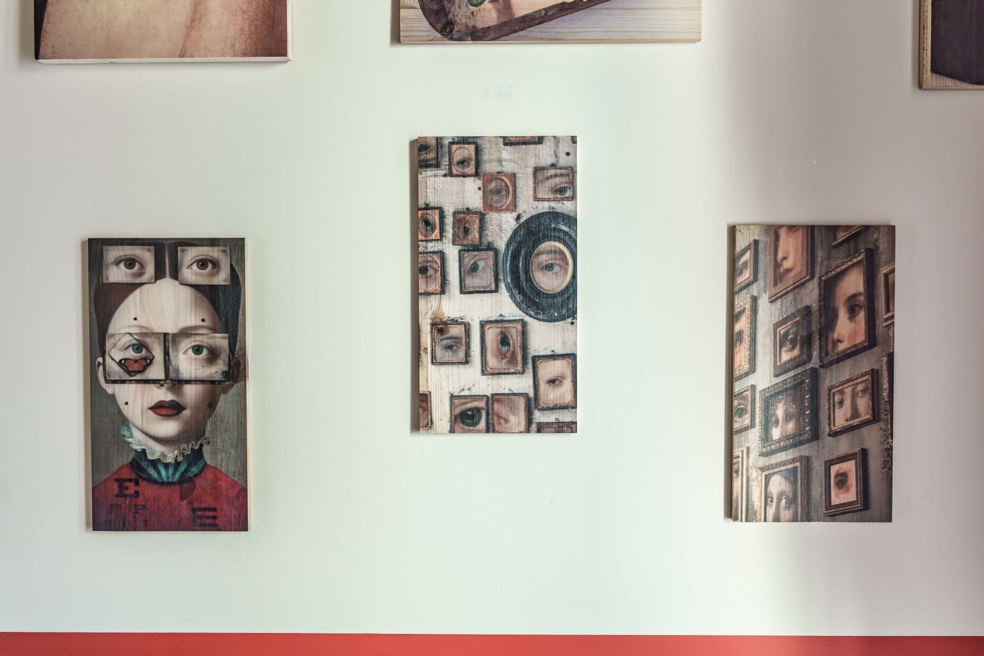 A wall with three artworks.